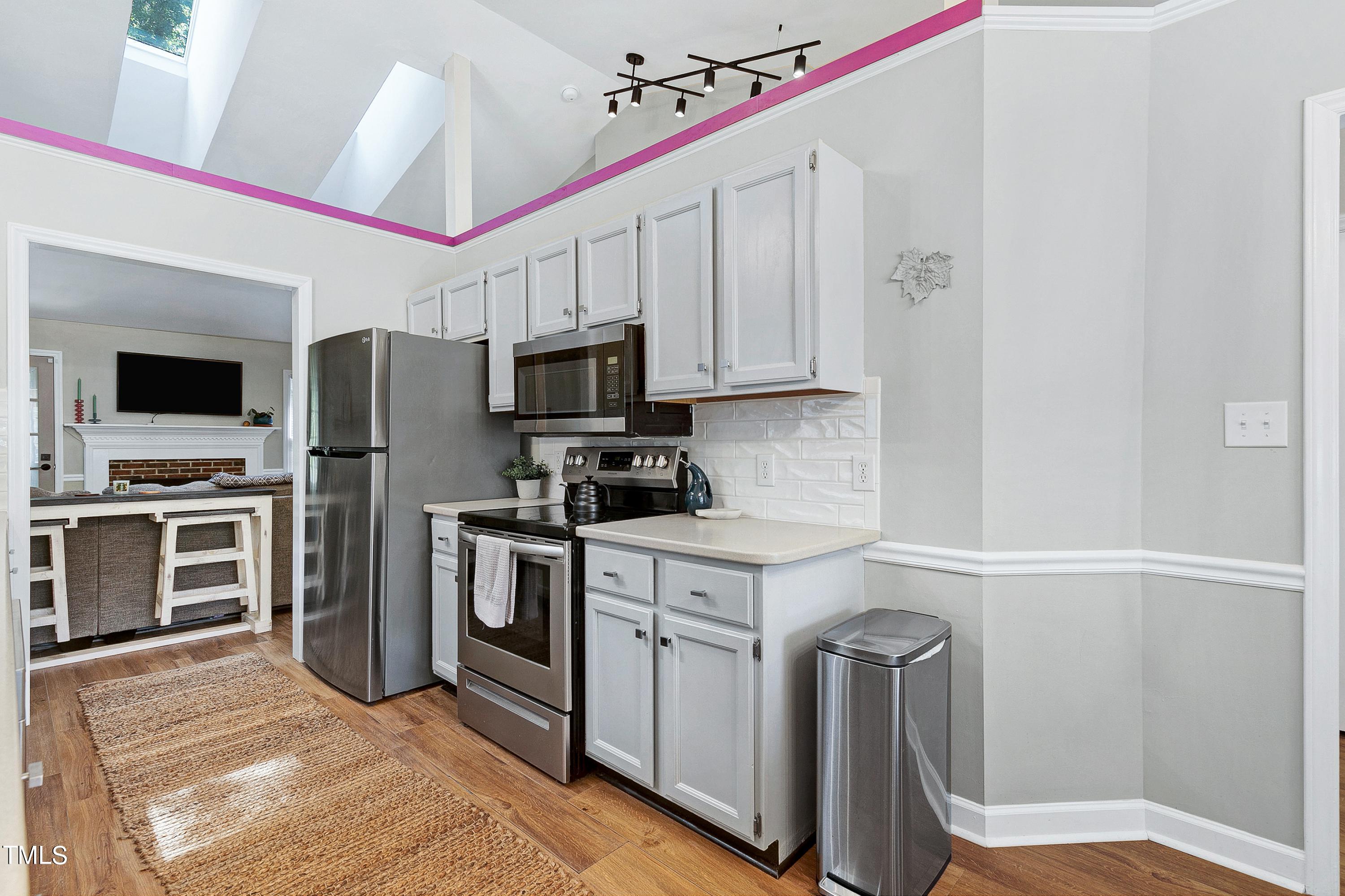 4700 Jacqueline Lane Raleigh, NC 27616 - Photo 11 of 40 a kitchen with a refrigerator stove and microwave