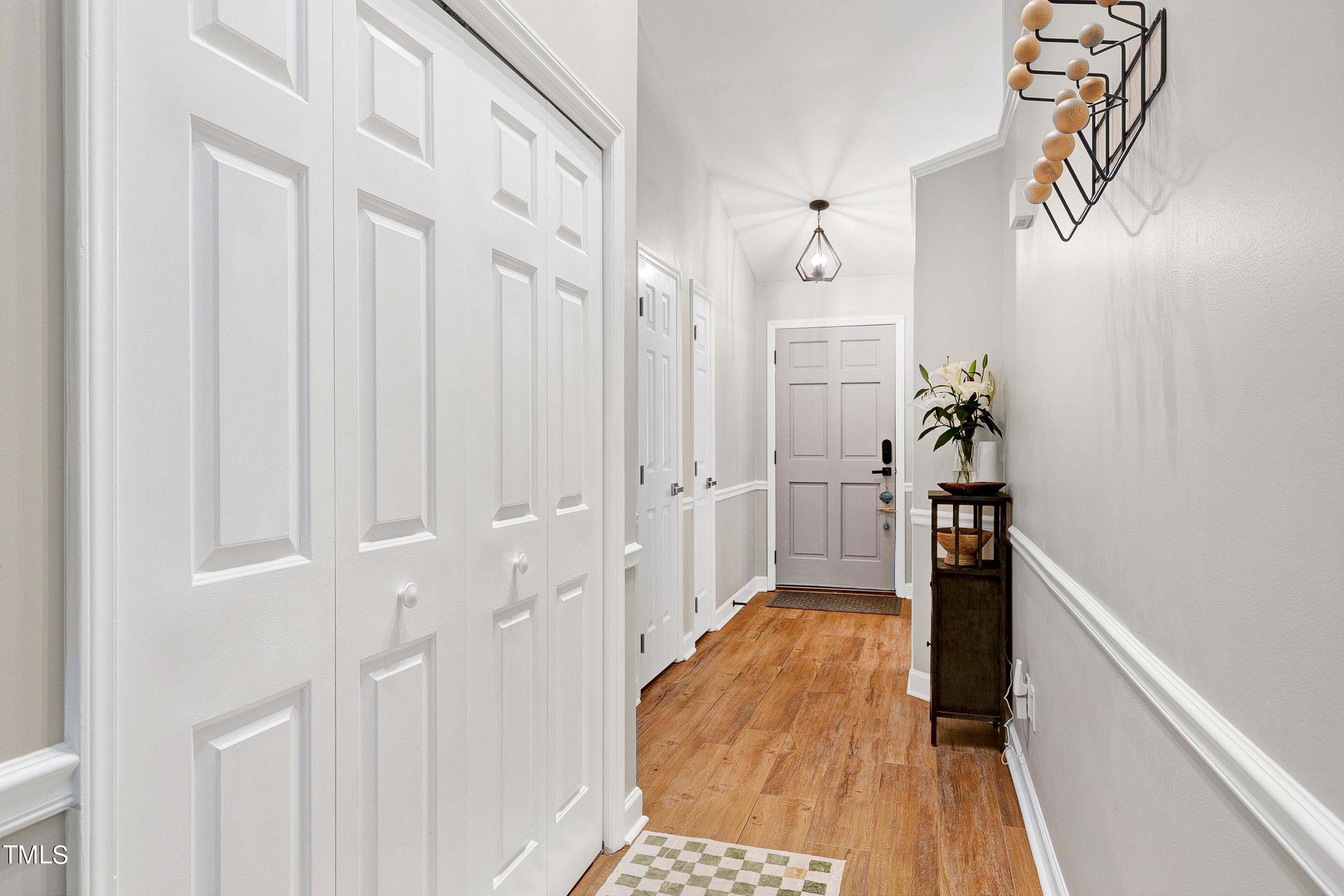 4700 Jacqueline Lane Raleigh, NC 27616 - Photo 15 of 40 a view of a hallway with wooden floor and staircase