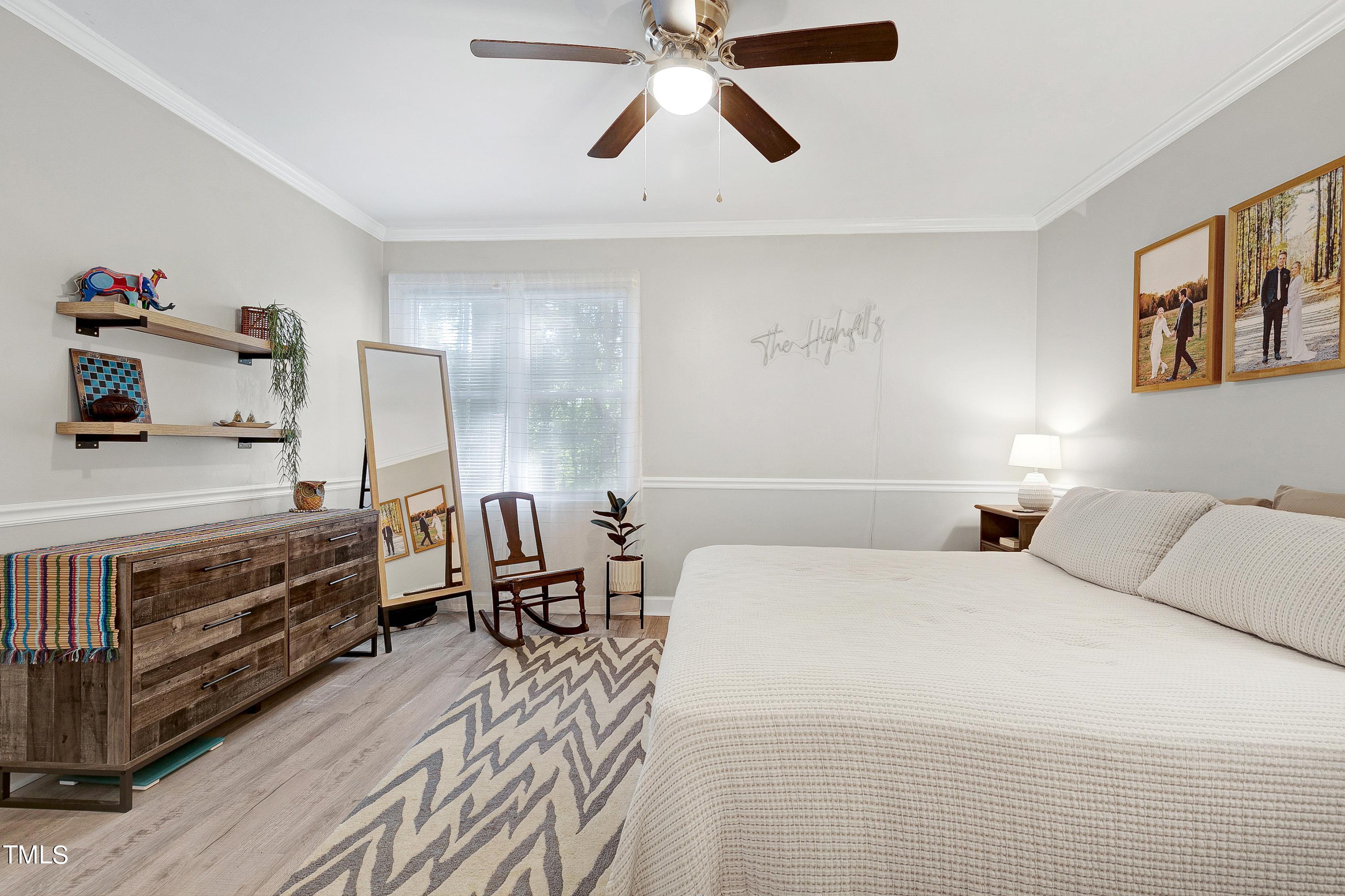 4700 Jacqueline Lane Raleigh, NC 27616 - Photo 23 of 40 a bedroom with a bed and wooden floor