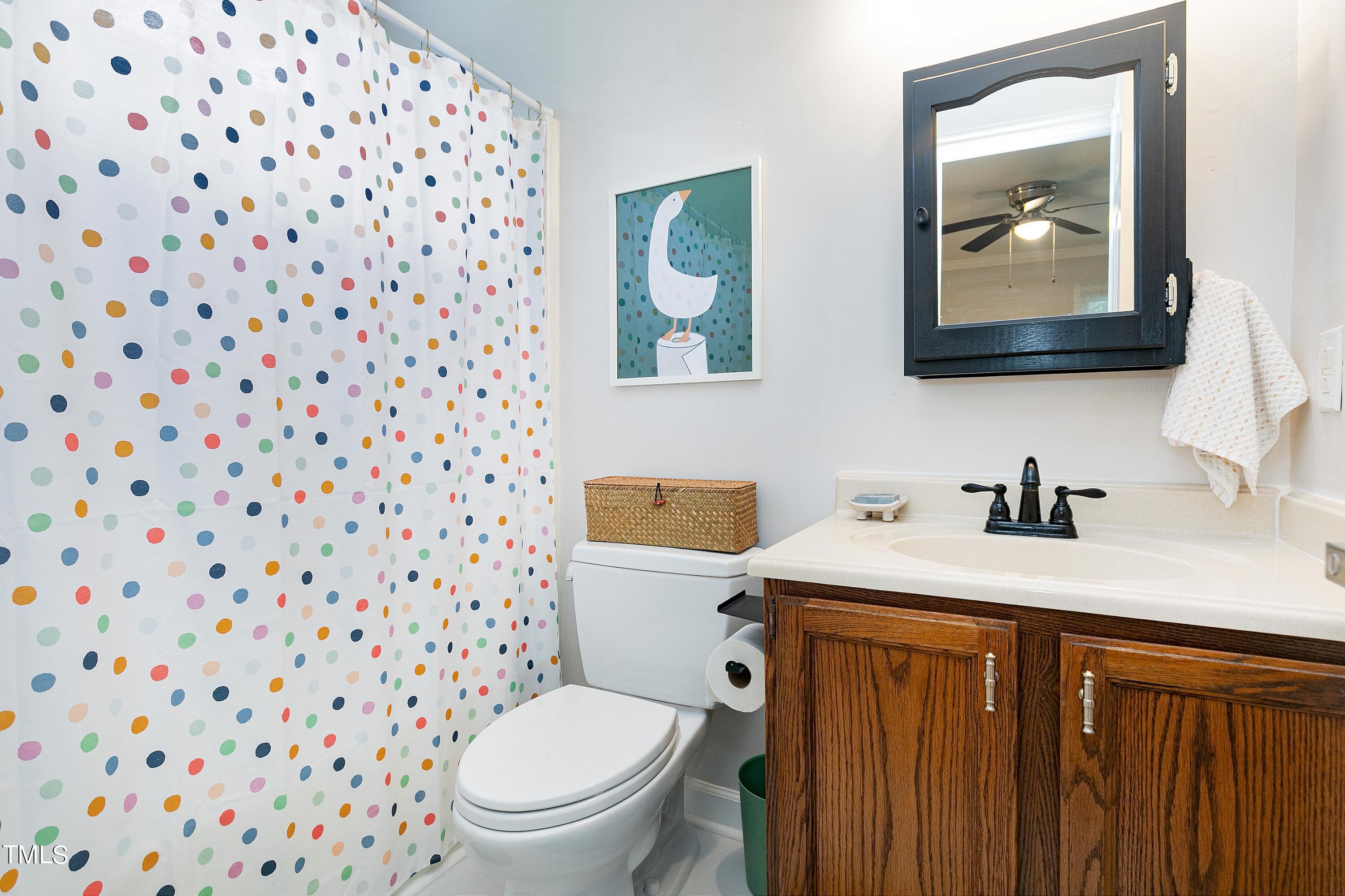 4700 Jacqueline Lane Raleigh, NC 27616 - Photo 24 of 40 a bathroom with a granite countertop sink and a toilet