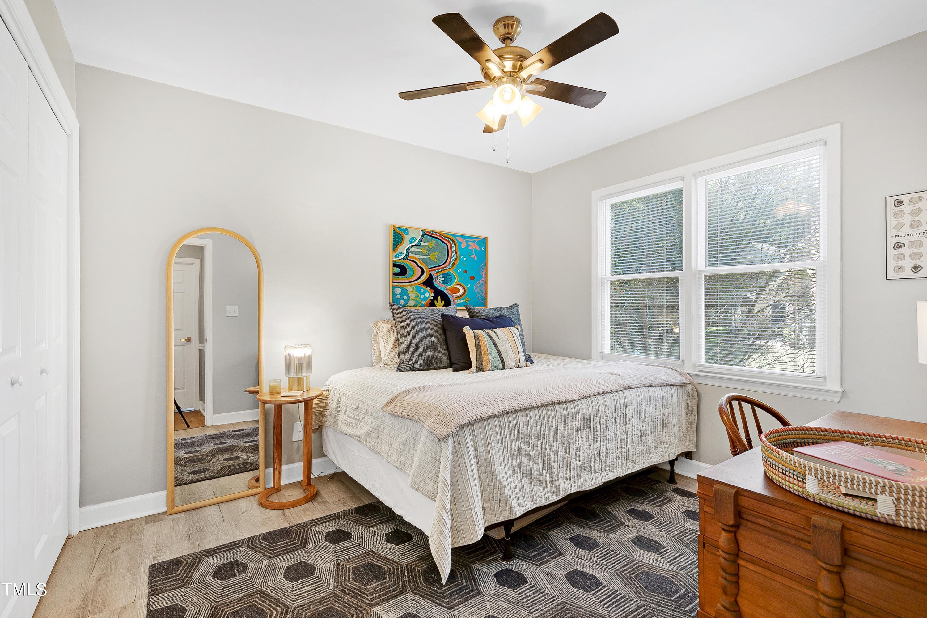 4700 Jacqueline Lane Raleigh, NC 27616 - Photo 27 of 40 a bedroom with a bed and wooden floor