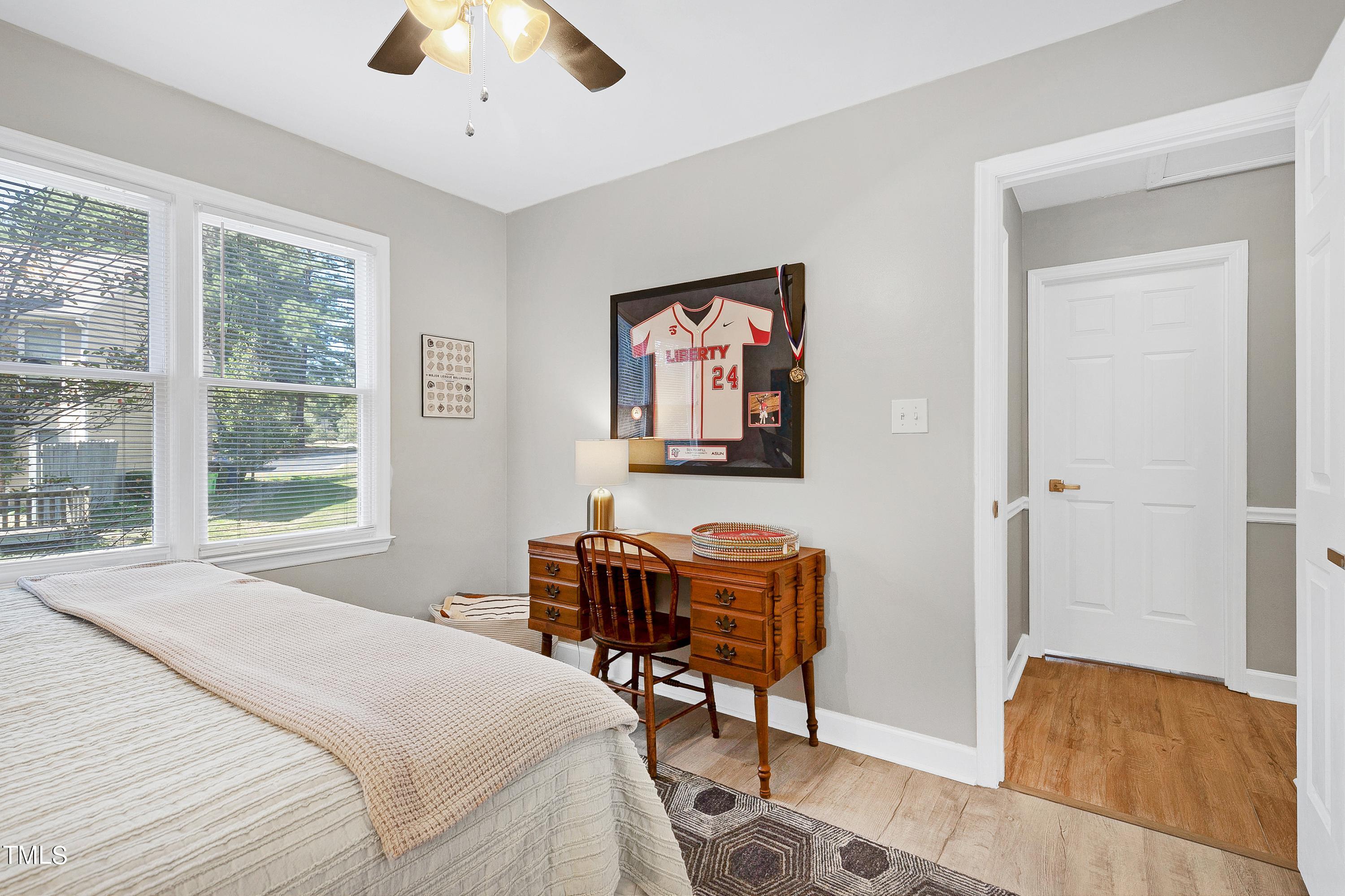 4700 Jacqueline Lane Raleigh, NC 27616 - Photo 28 of 40 a bedroom with a bed and a chandelier