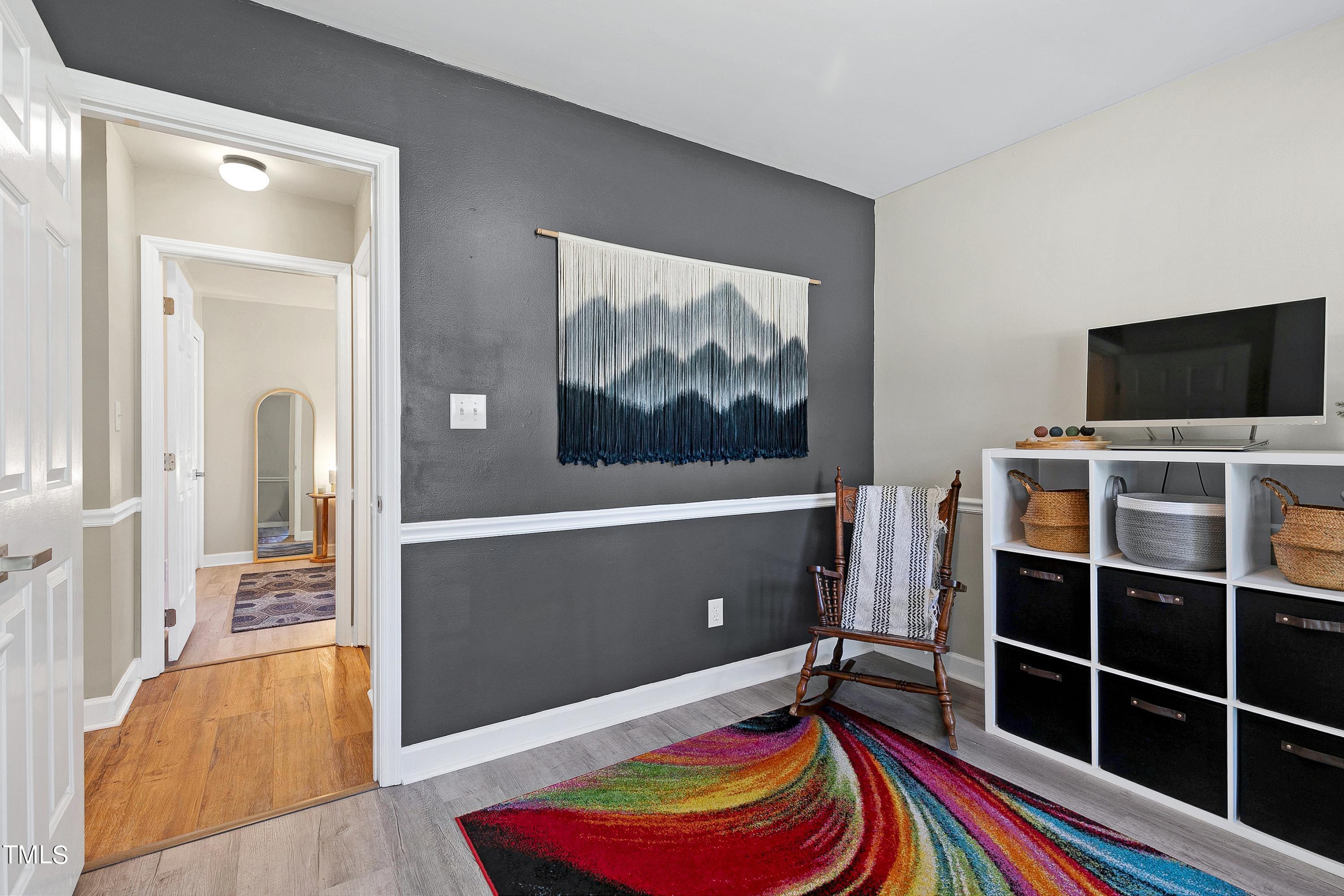 4700 Jacqueline Lane Raleigh, NC 27616 - Photo 32 of 40 a room with furniture and a flat screen tv