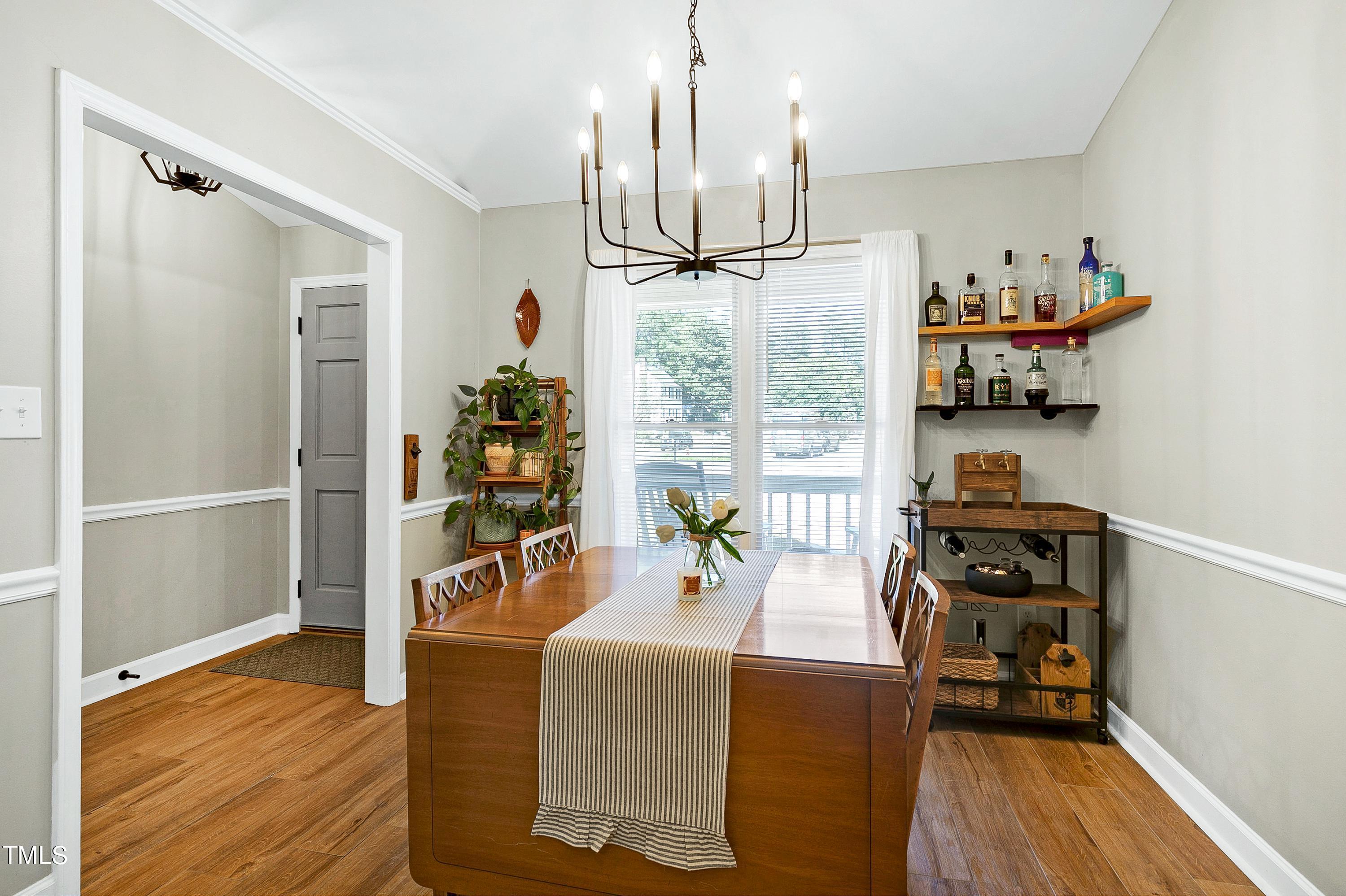 4700 Jacqueline Lane Raleigh, NC 27616 - Photo 8 of 40 a view of a dining room with furniture wooden floor and a chandelier