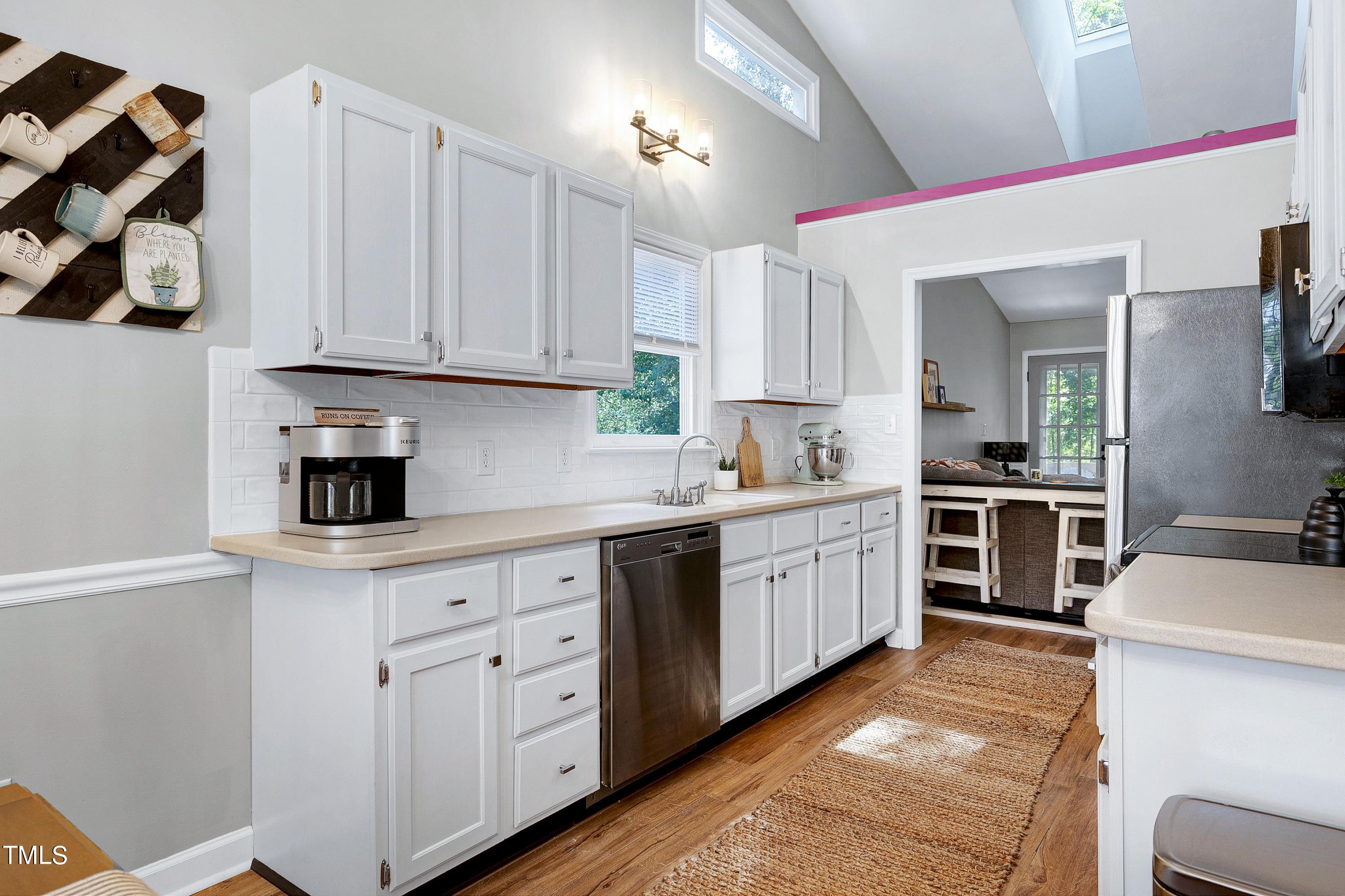 4700 Jacqueline Lane Raleigh, NC 27616 - Photo 9 of 40 a kitchen with white cabinets and white appliances