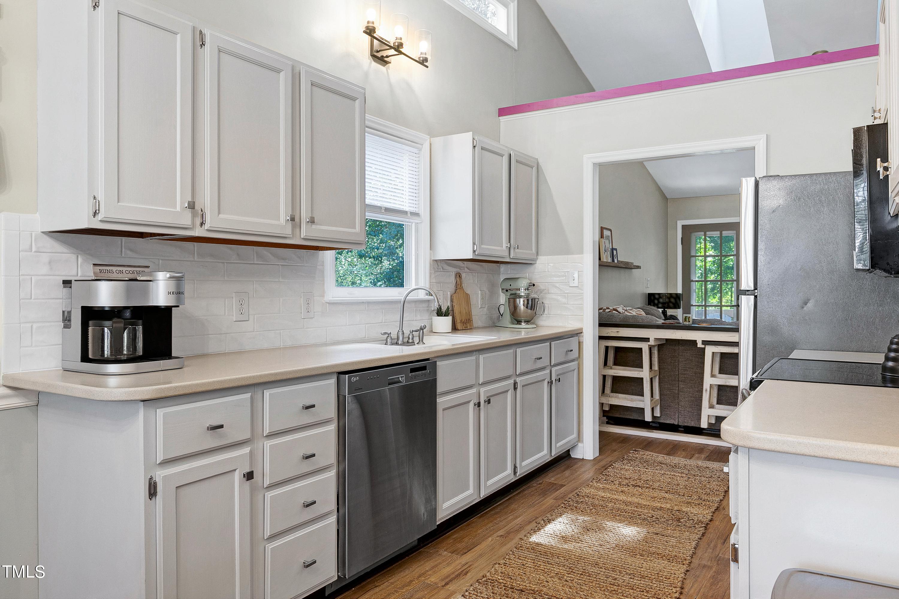 4700 Jacqueline Lane Raleigh, NC 27616 - Photo 10 of 40 a kitchen with cabinets appliances and a window