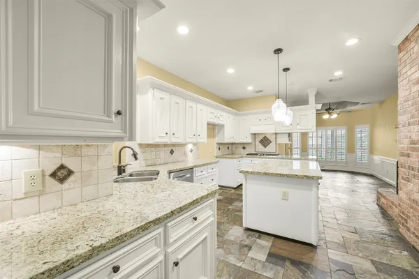 a kitchen with stainless steel appliances granite countertop a sink stove and cabinets