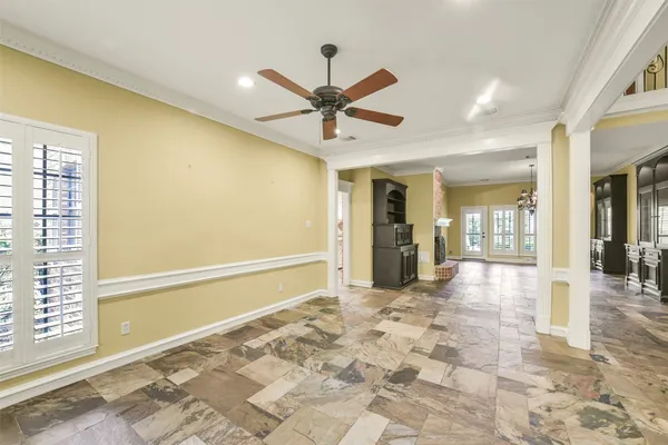 a view of a livingroom with a ceiling fan and window