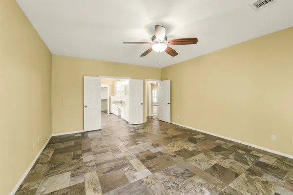 a view of a big room with wooden floor and windows in a room
