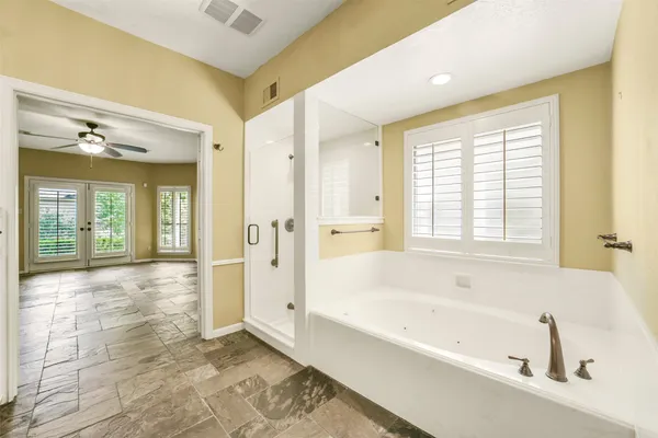 a spacious bathroom with a bathtub and a shower