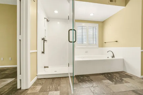 a bathroom with a bathtub and a shower