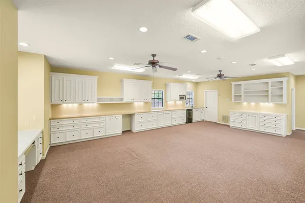 a view of a kitchen with refrigerator and a sink