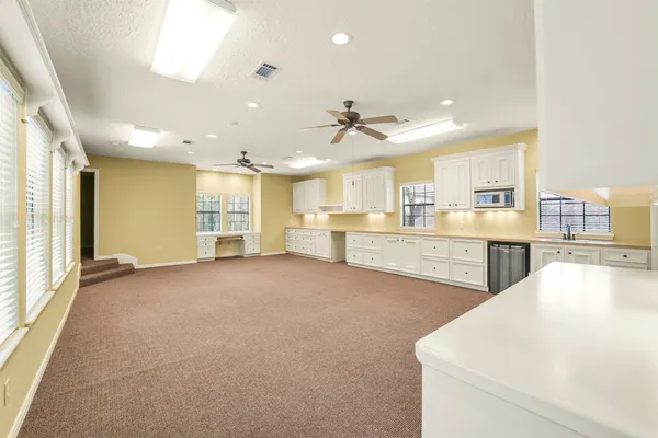 a view of a kitchen with a sink and cabinets