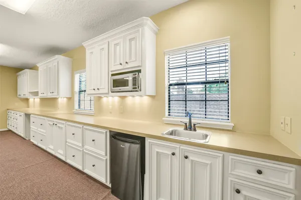 a kitchen with sink cabinets and window