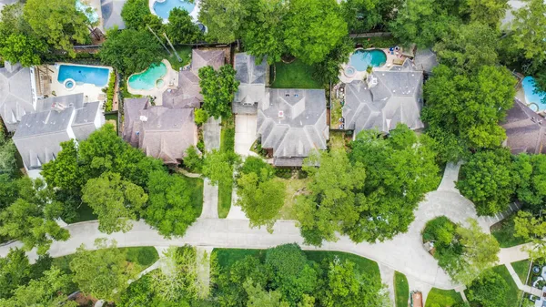 an aerial view of a house with a yard and garden