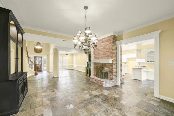 a view of a big room with windows and chandelier