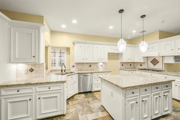 a kitchen with a sink a stove and cabinets
