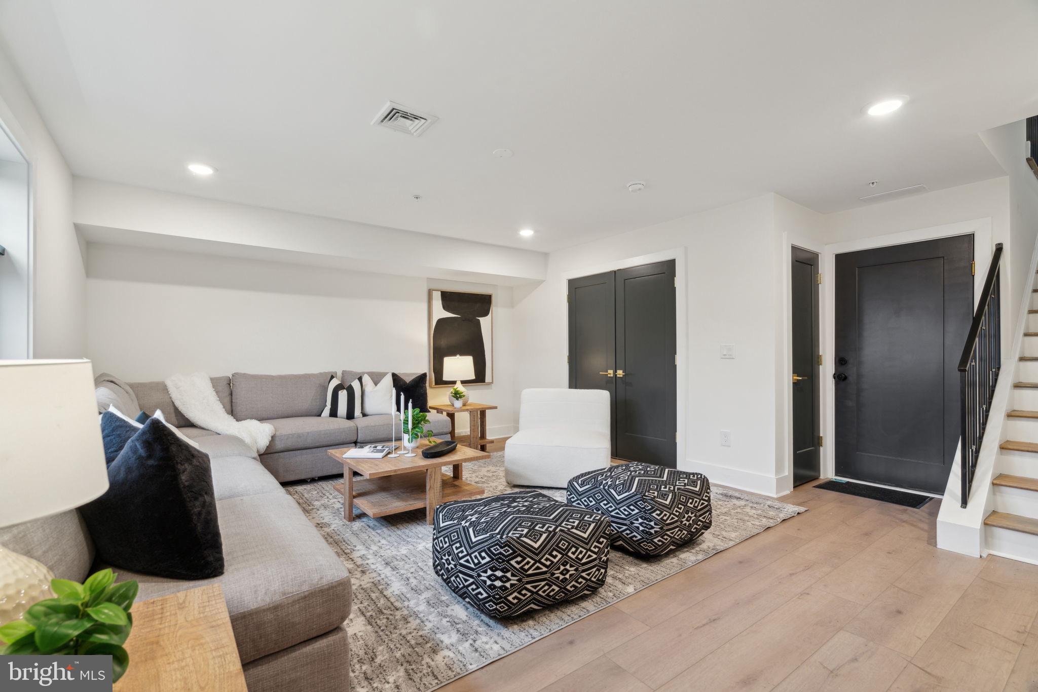 7519 Ridge Avenue, Unit 304 Philadelphia, PA 19128 - Photo 17 of 38 a living room with furniture rug and wooden floor