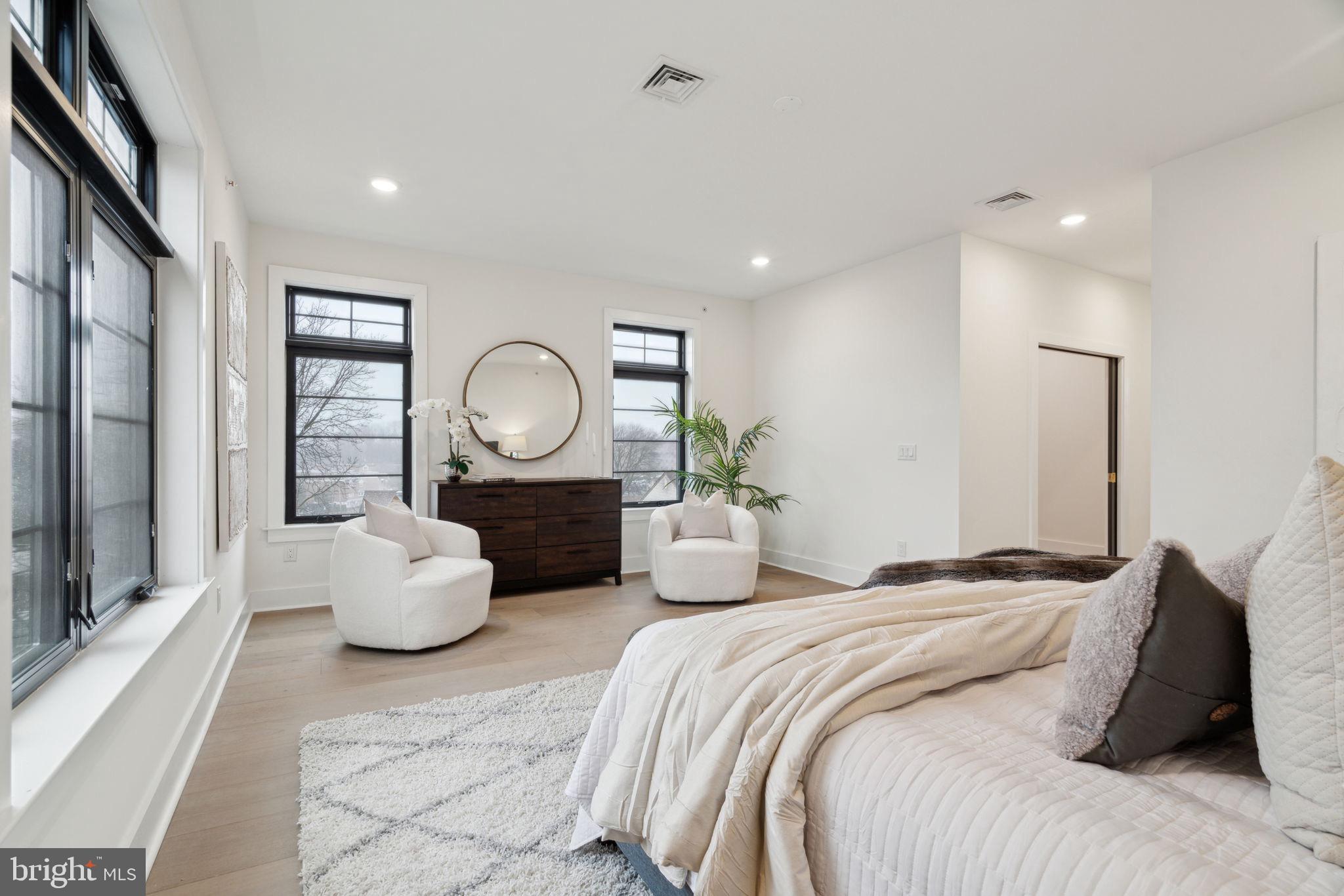 7519 Ridge Avenue, Unit 304 Philadelphia, PA 19128 - Photo 21 of 38 a bedroom with bed and a large window