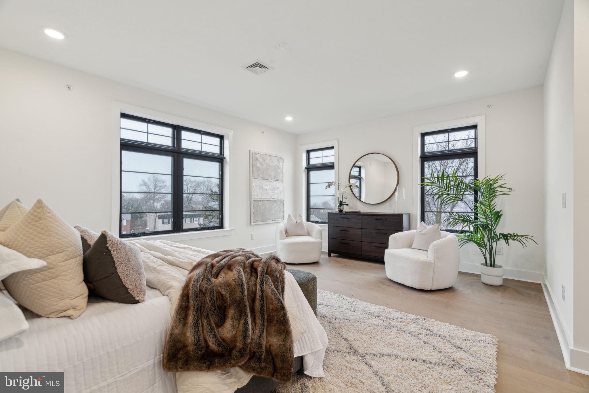 7519 Ridge Avenue, Unit 304 Philadelphia, PA 19128 - Photo 22 of 38 a spacious bedroom with a bed and a large window