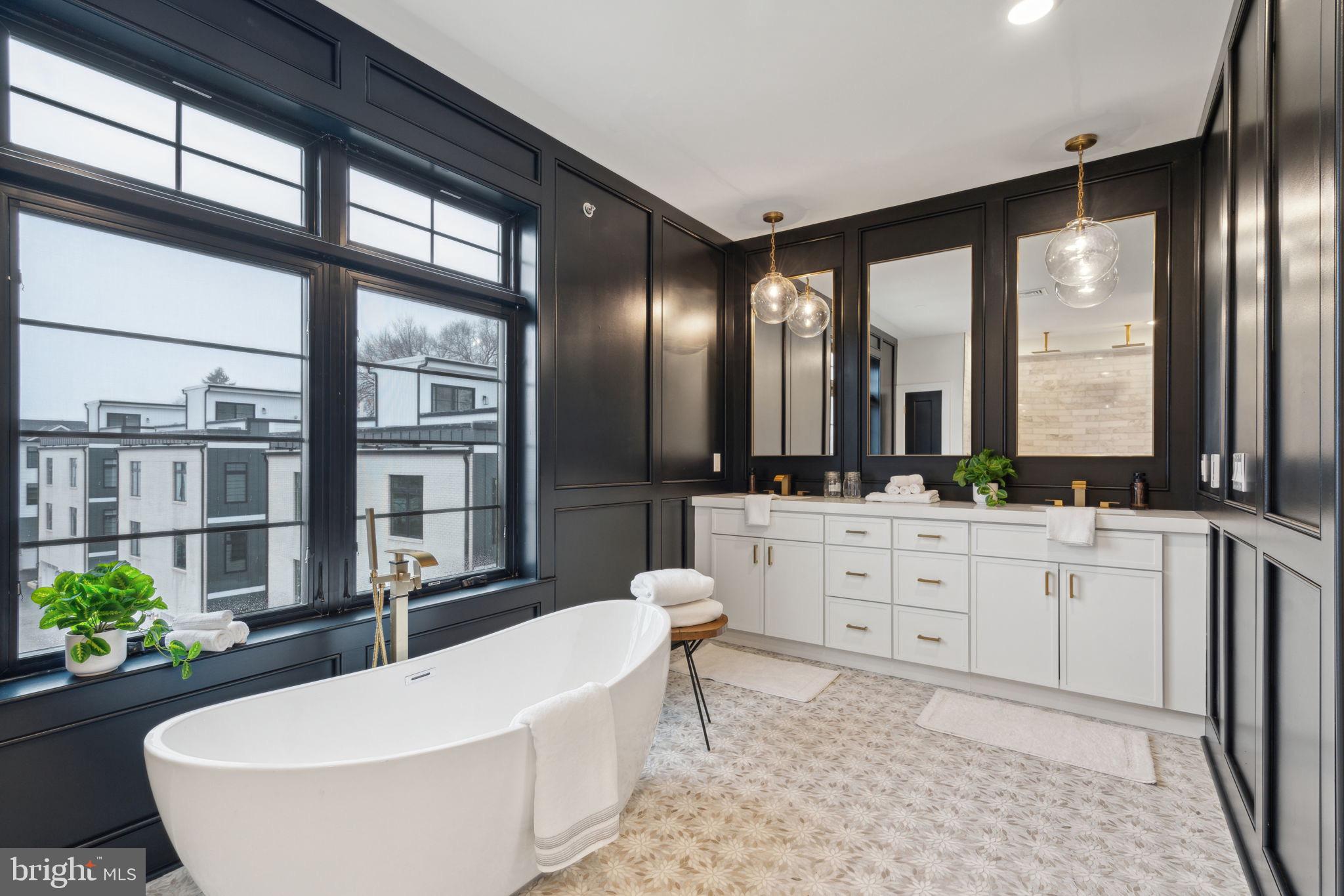 7519 Ridge Avenue, Unit 304 Philadelphia, PA 19128 - Photo 25 of 38 a large spacious bathroom with a large tub and chandelier