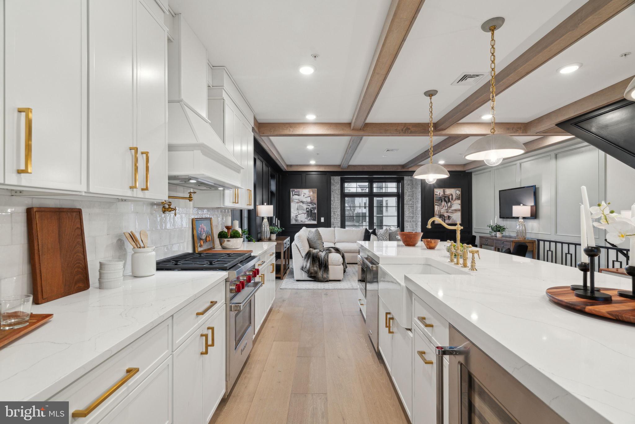 7519 Ridge Avenue, Unit 304 Philadelphia, PA 19128 - Photo 3 of 38 a large white kitchen with lots of counter space sink and a large window