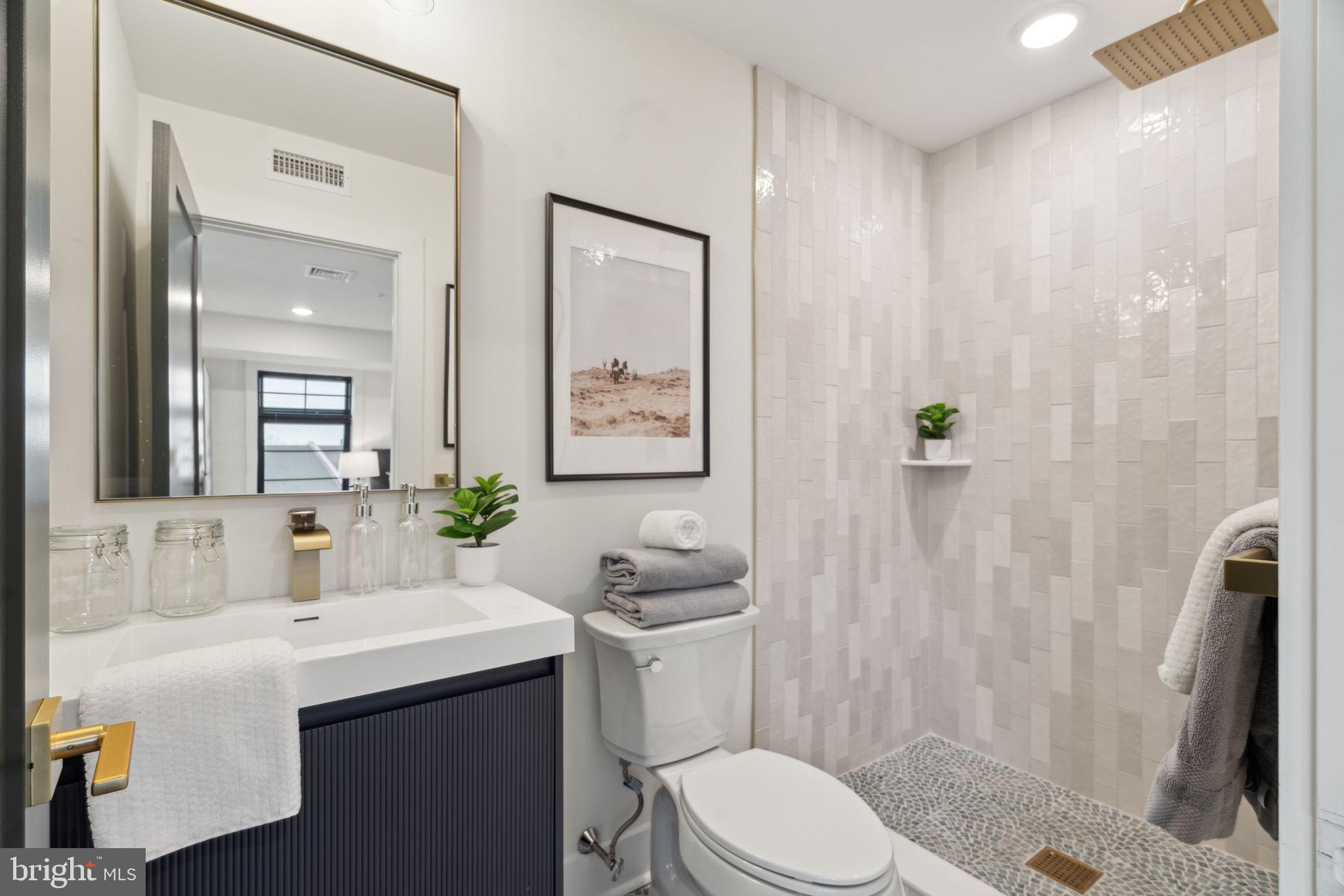 7519 Ridge Avenue, Unit 304 Philadelphia, PA 19128 - Photo 33 of 38 a bathroom with a sink toilet and shower