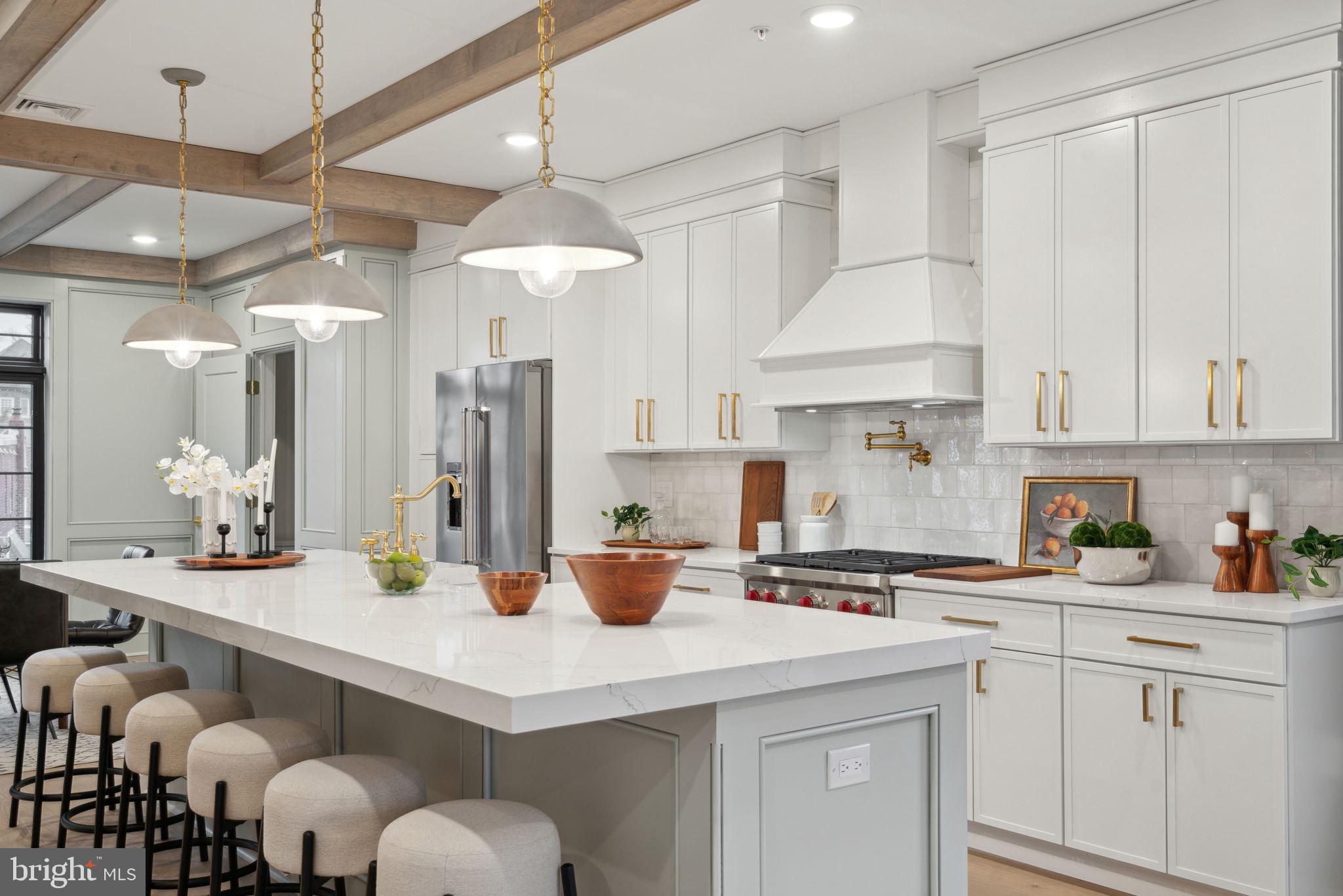 7519 Ridge Avenue, Unit 304 Philadelphia, PA 19128 - Photo 6 of 38 a kitchen with stainless steel appliances a sink a stove a refrigerator and white cabinets