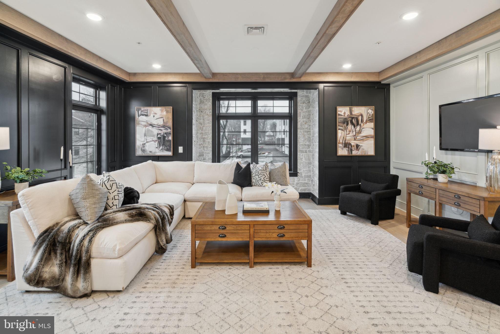 7519 Ridge Avenue, Unit 304 Philadelphia, PA 19128 - Photo 9 of 38 a living room with furniture ceiling fan and a flat screen tv