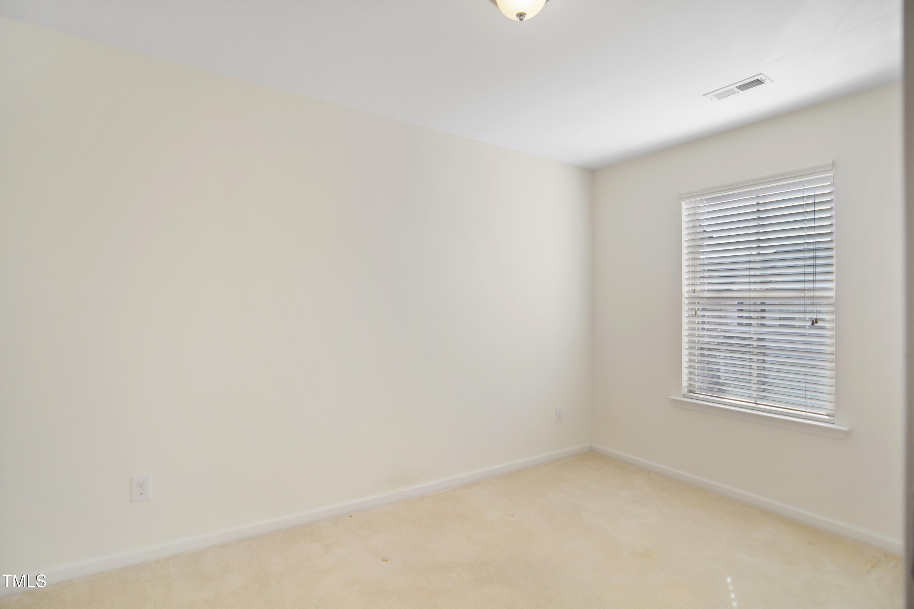 2901 Benevolence Drive Raleigh, NC 27610 - Photo 15 of 18 a view of an empty room with a window