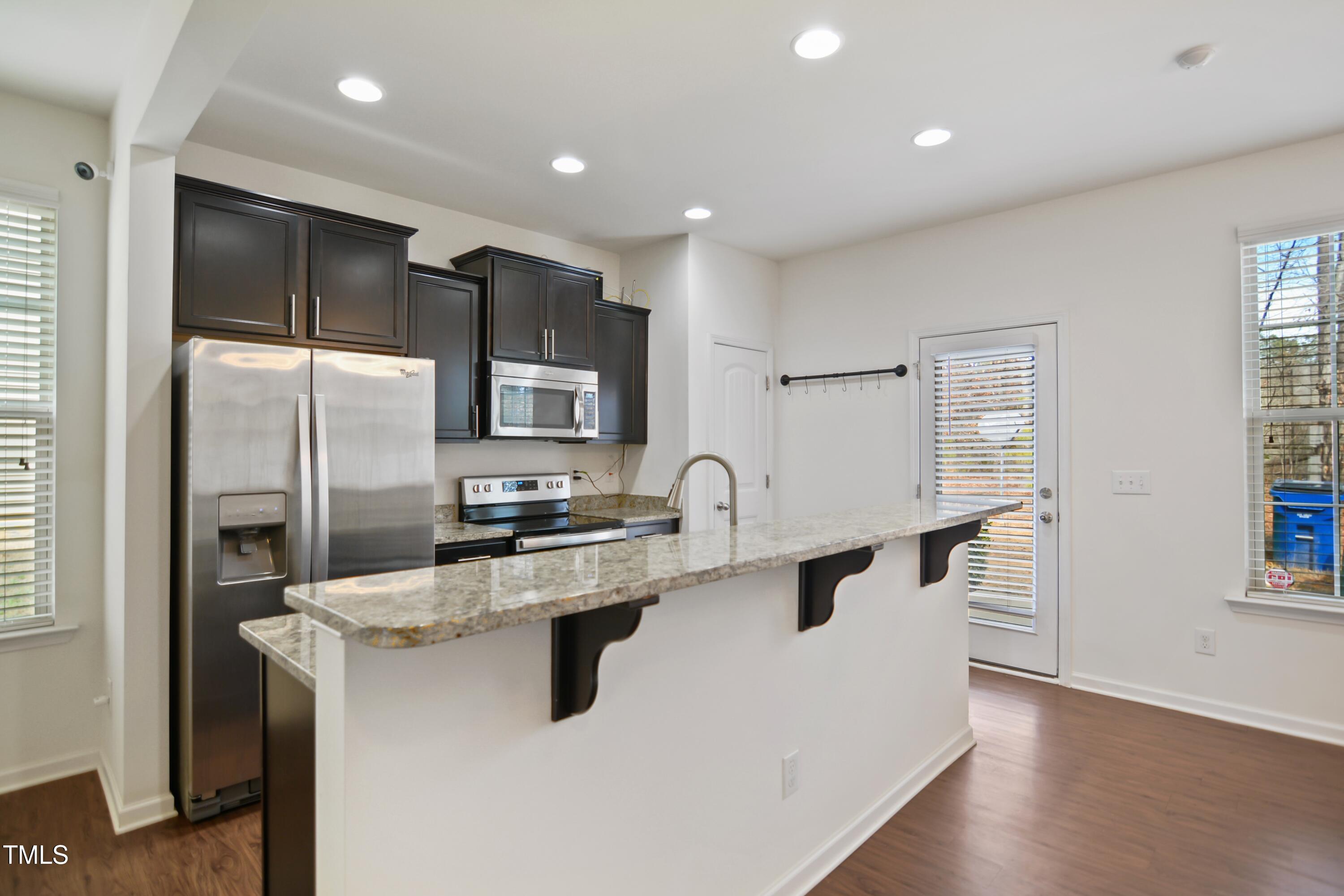 2901 Benevolence Drive Raleigh, NC 27610 - Photo 6 of 18 a kitchen with stainless steel appliances a refrigerator sink and microwave