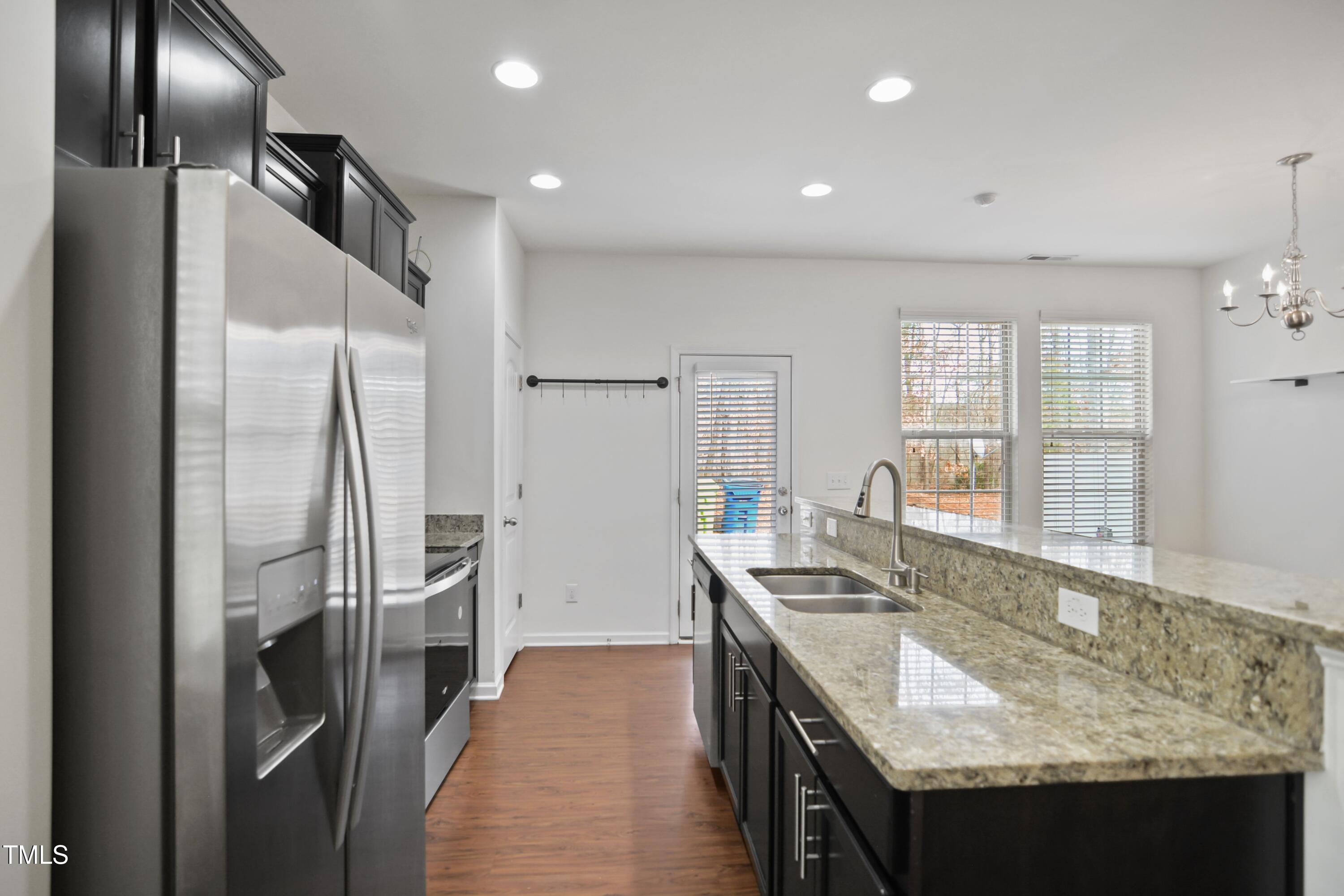 2901 Benevolence Drive Raleigh, NC 27610 - Photo 7 of 18 a kitchen with stainless steel appliances granite countertop a sink stove and refrigerator
