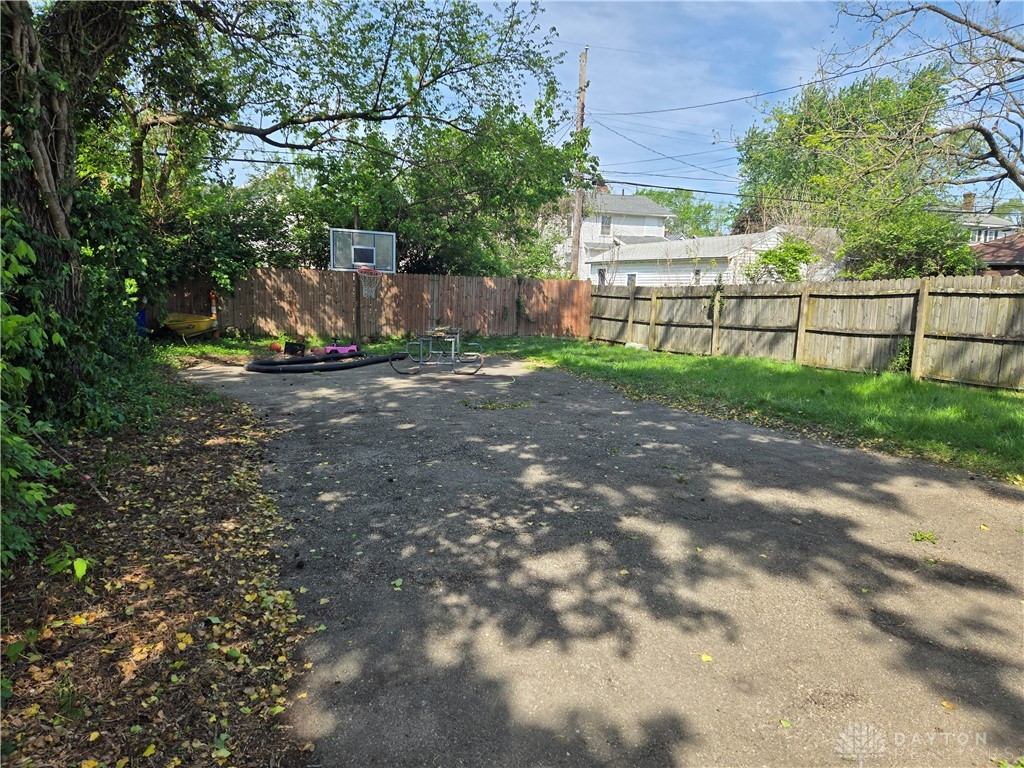 355 Elmhurst Road Dayton, OH 45417 - Photo 5 of 19 This spacious yard offers ample outdoor living potential, featuring a sturdy privacy fence and natural landscaping.