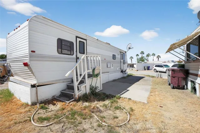 a view of a livingroom with wooden floor and staircase