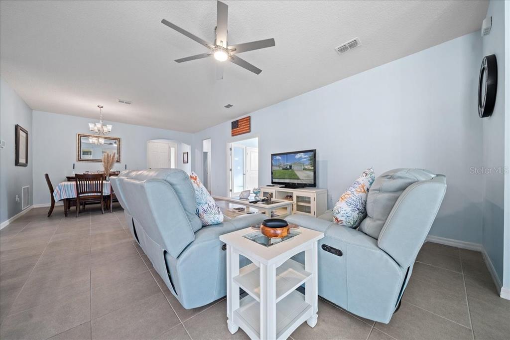 6138 Southwest 89th Ln Road Ocala, FL 34476 - Photo 31 of 74 a living room with furniture and a flat screen tv