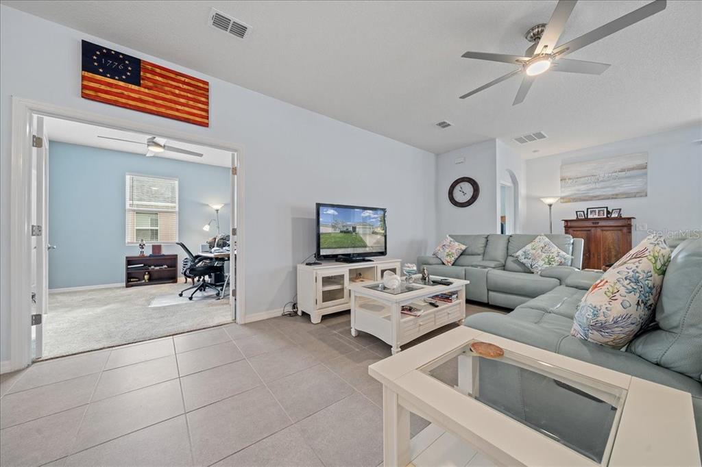 6138 Southwest 89th Ln Road Ocala, FL 34476 - Photo 32 of 74 a living room with furniture and a flat screen tv