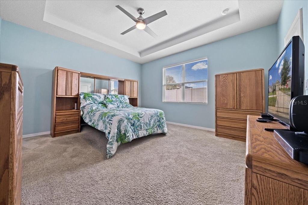 6138 Southwest 89th Ln Road Ocala, FL 34476 - Photo 34 of 74 a living room with furniture and a flat screen tv