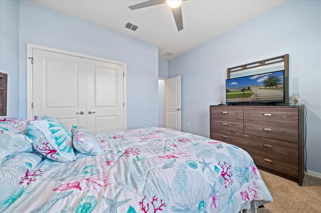 6138 Southwest 89th Ln Road Ocala, FL 34476 - Photo 46 of 74 a bedroom with a bed and a flat screen tv in it