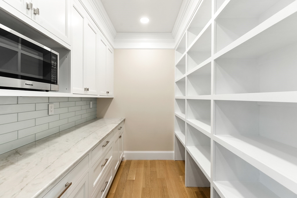320 Concord Avenue Lexington, MA 02421 - Photo 9 of 40 a view of a kitchen with cabinets and wooden floor