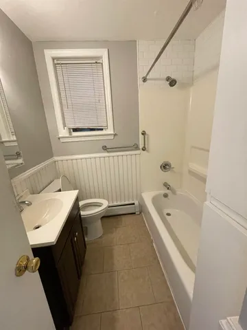 a bathroom with a sink a toilet and bathtub