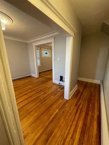 a view of a room with wooden floor and staircase