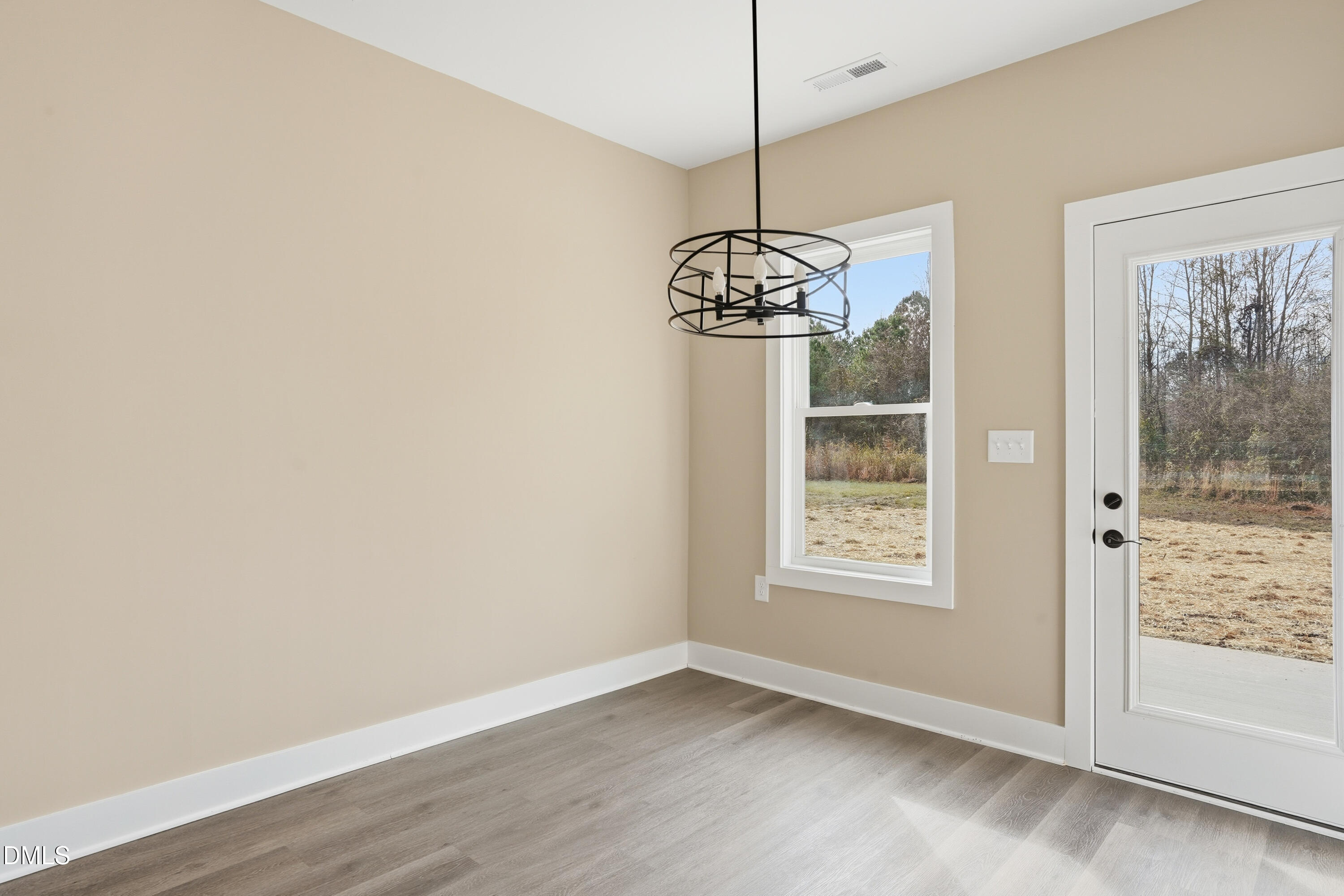 1115 Jada Allen Road Dunn, NC 28334 - Photo 8 of 32 a view of an empty room with window and chandelier