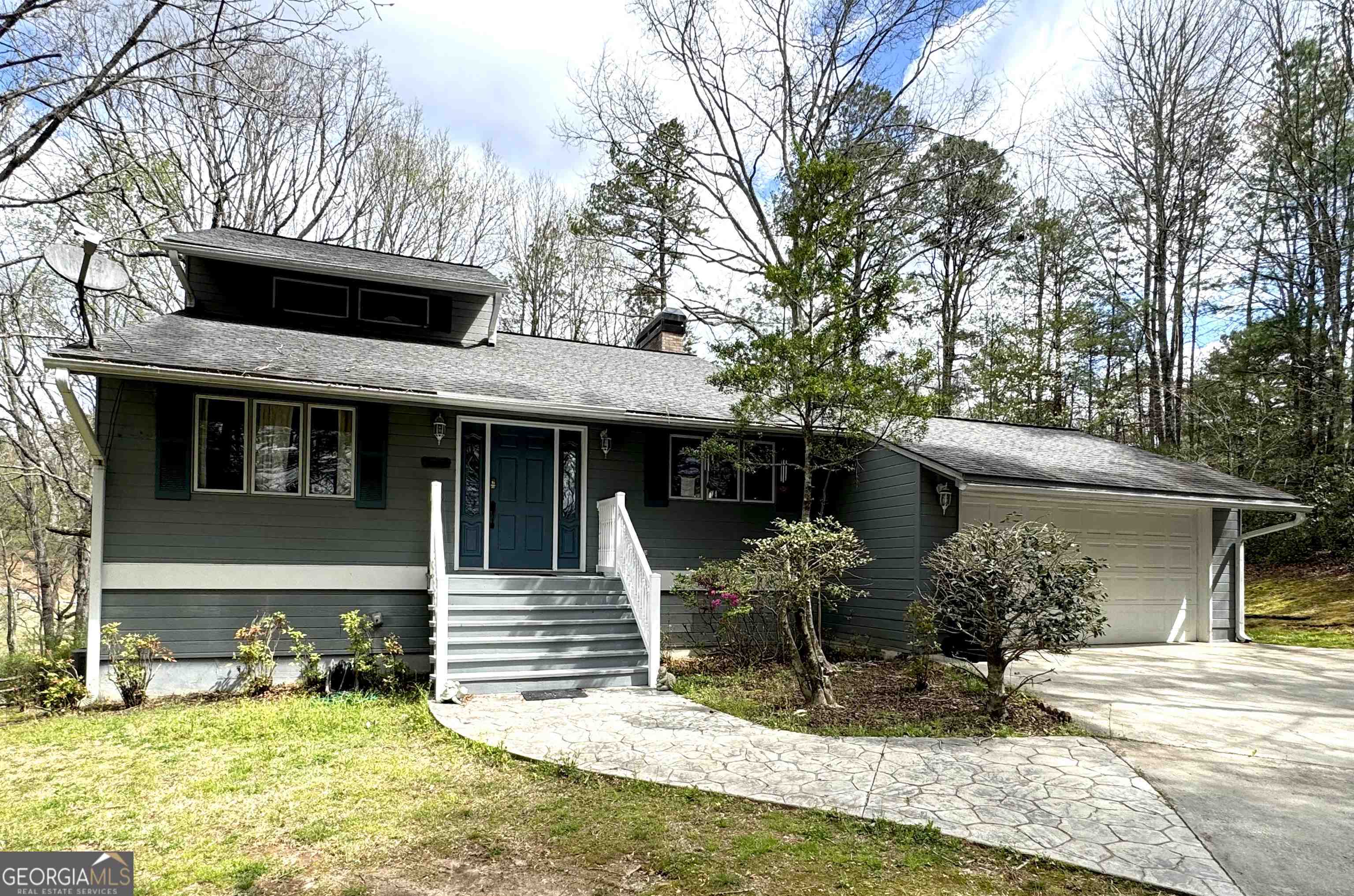 a view of a house with backyard space and sitting area