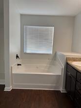313 Clover Brook Drive Locust Grove, GA 30248 - Photo 13 of 13 a bathroom with a bathtub and a window