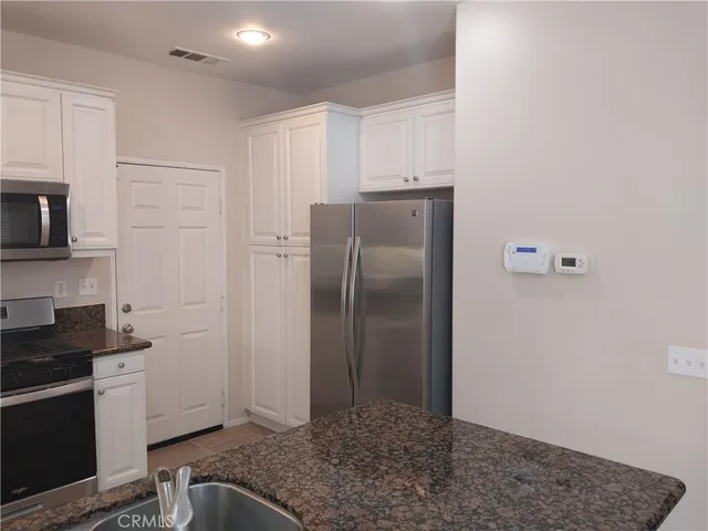 a kitchen with a refrigerator and a sink