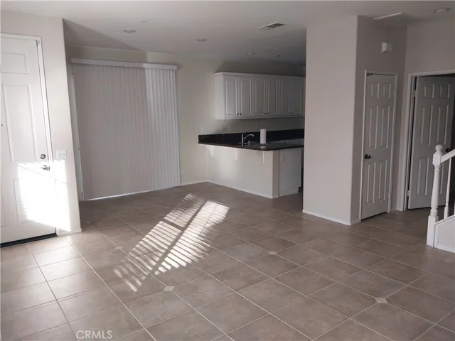 a view of kitchen with refrigerator and window