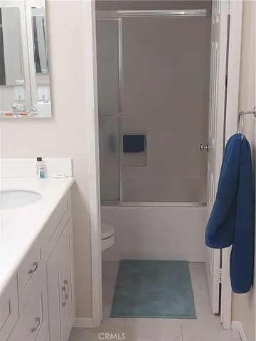a bathroom with a bathtub sink vanity and toilet