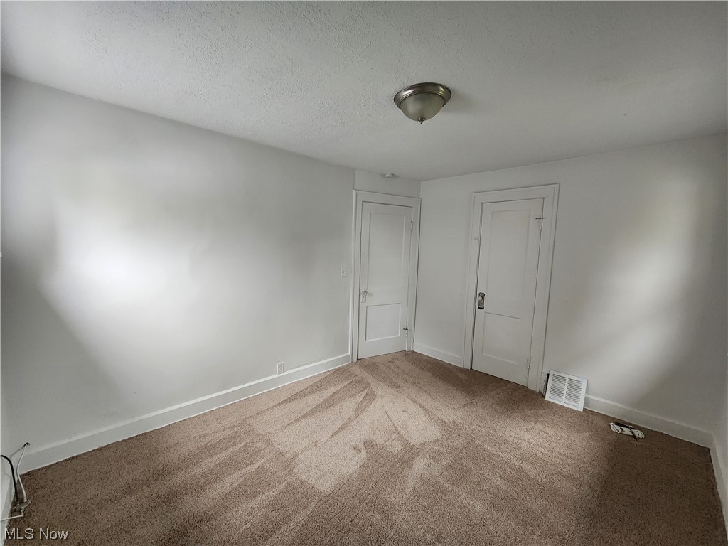 13417 Rugby Road Cleveland, OH 44110 - Photo 21 of 26 Carpeted empty room featuring a textured ceiling