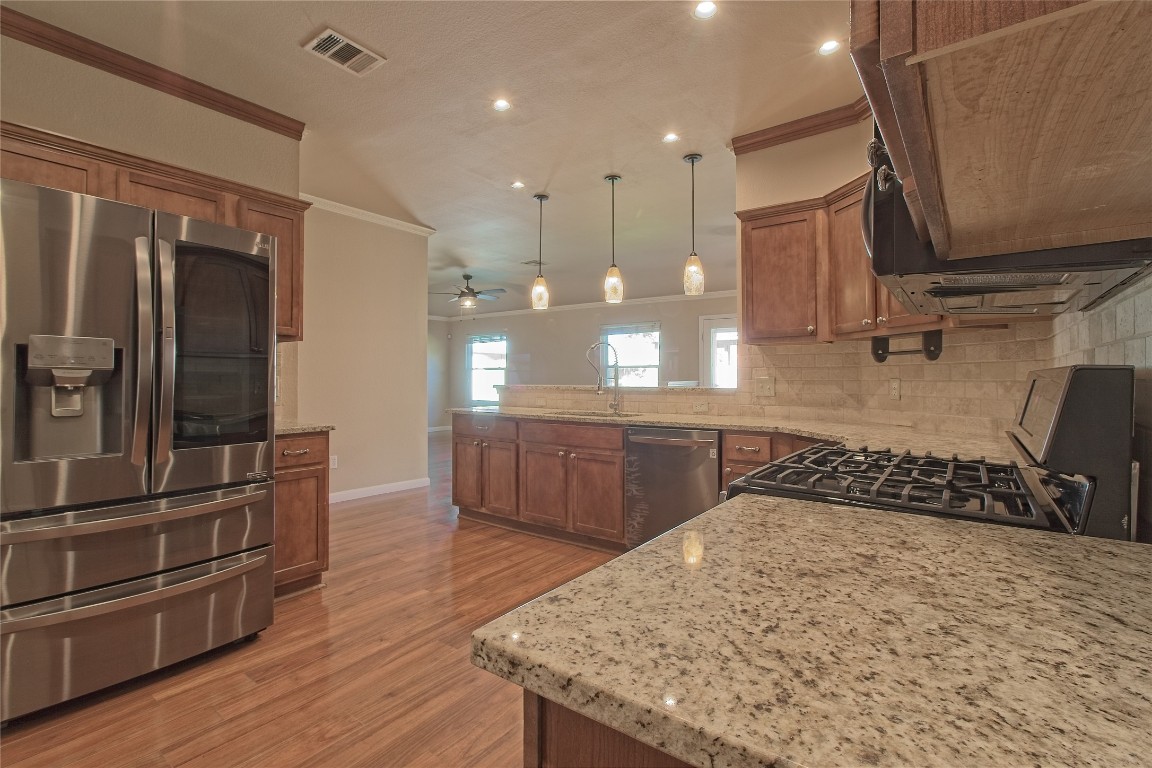 3112 Clinton Place Round Rock, TX 78665 - Photo 16 of 36 a kitchen with stainless steel appliances granite countertop a sink a stove and a refrigerator