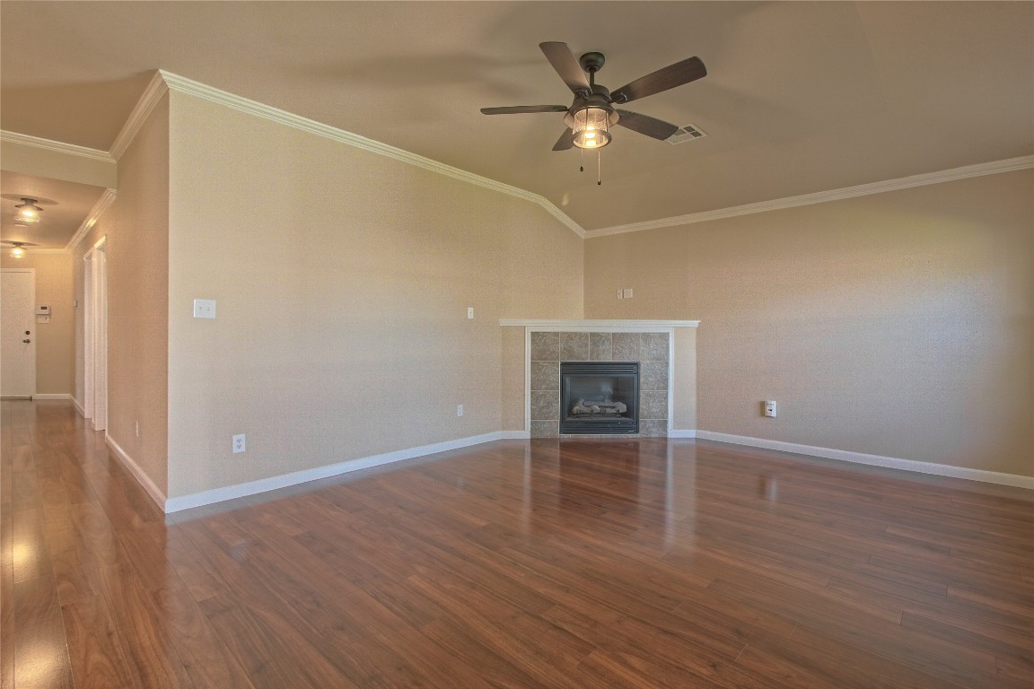 3112 Clinton Place Round Rock, TX 78665 - Photo 18 of 36 an empty room with wooden floor and ceiling fan